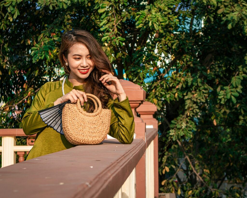 How Long Does Mystic Tan Last? Tips to Make Your Spray Tan Last Longer a woman holding a wicker basket on a balcony